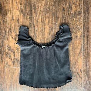Black off-the-shoulder crop top from Urban Outfitters.